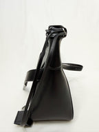 Black leather handbag on a white background