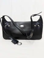 Black leather handbag with a shoulder strap on a white background