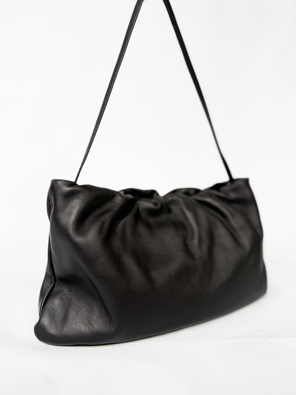 Black leather shoulder bag on a white background
