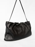 Black leather shoulder bag on a white background