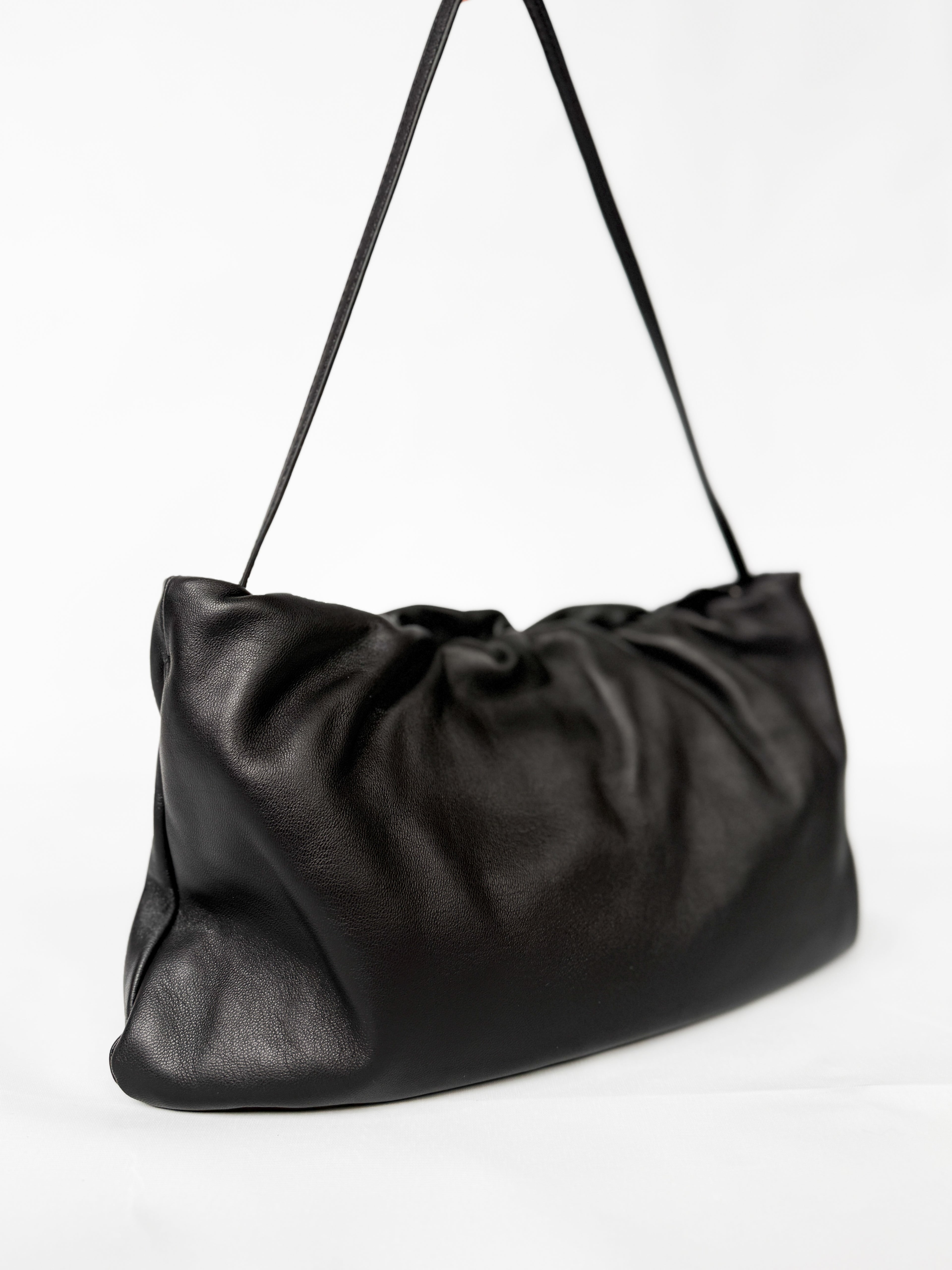 Black leather shoulder bag on a white background